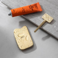 AKT, THE ASSISTANT. Tube squeezer key — The key to ZERO WASTE. 100% PLASTIC FREE & RECYCLABLE — Squeeze out every last drop of your NATURAL DEODORANT BALM from AKT LONDON